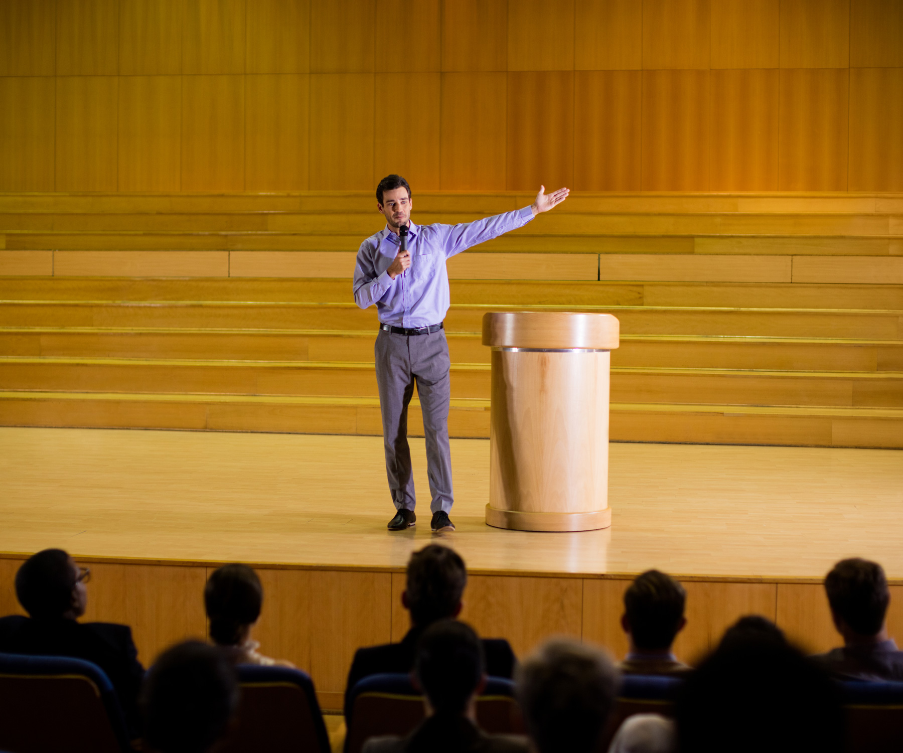 Photo of a presenter giving a speech to a crowd