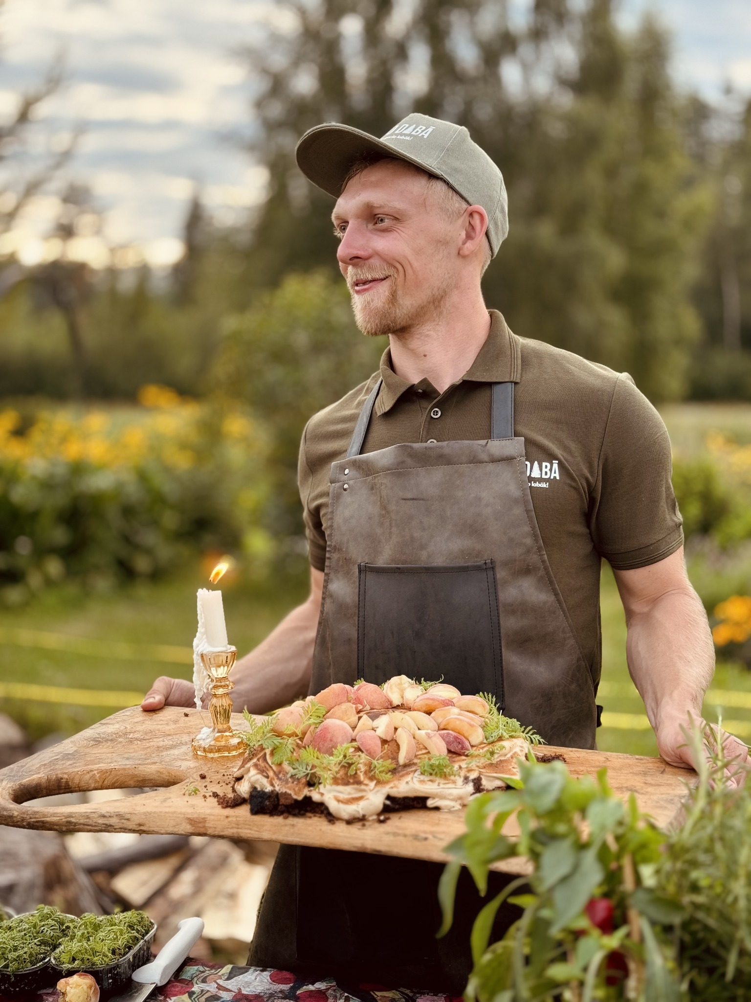 Chef Renārs Purmalis serving a meal outdoors