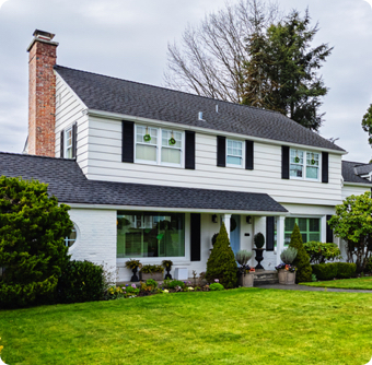 Colonial style home exterior on a bright overcast spring day