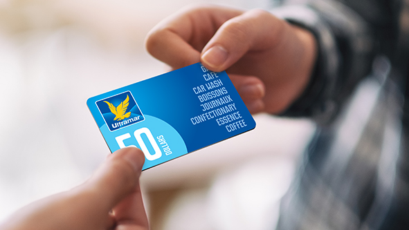 Hands holding an Ultramar gift card.