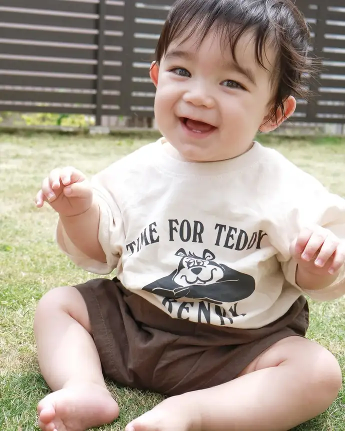 芝生の上で笑う赤ちゃん