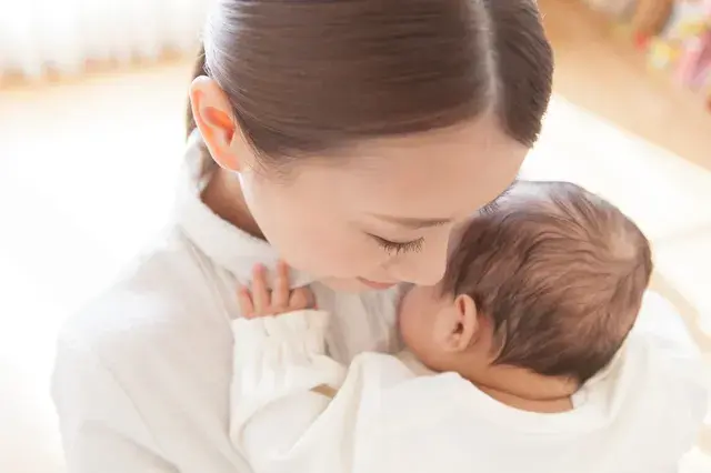 赤ちゃんを抱きしめるママ