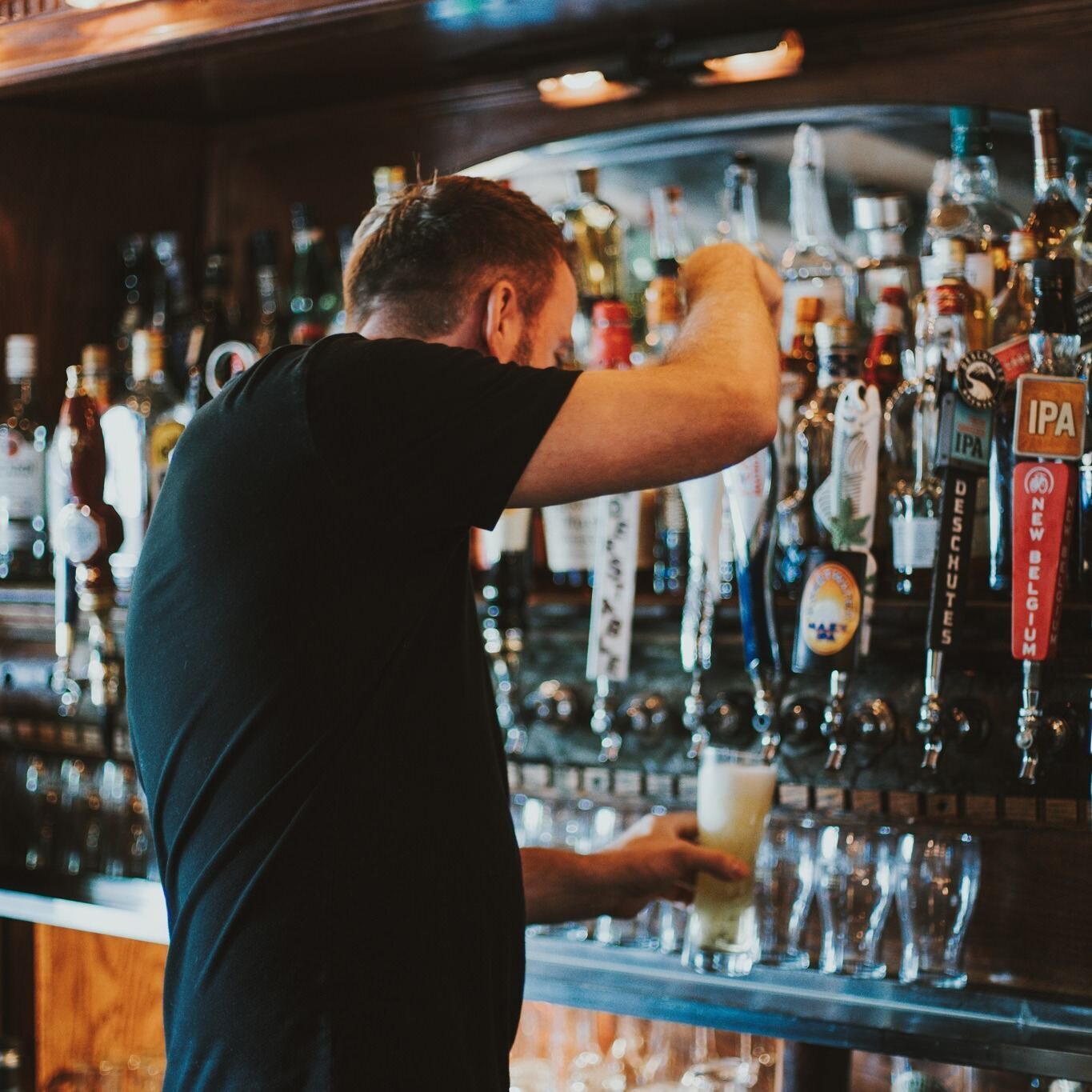 A bartender pouring beer