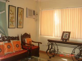 Living room (airconditioned) that is carpeted. Furniture set called 