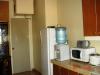 Kitchen with refrigerator, microwave oven, water dispenser. The table top is made from granite.