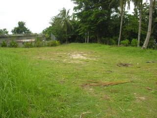 Large flat building area with fence at hilltop