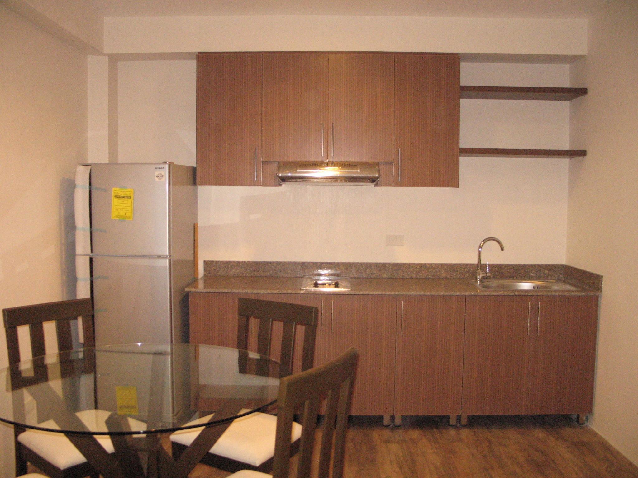 Kitchen Area with Refrigerator, 2 Burners w/ ranghood, Dining table w/ chairs