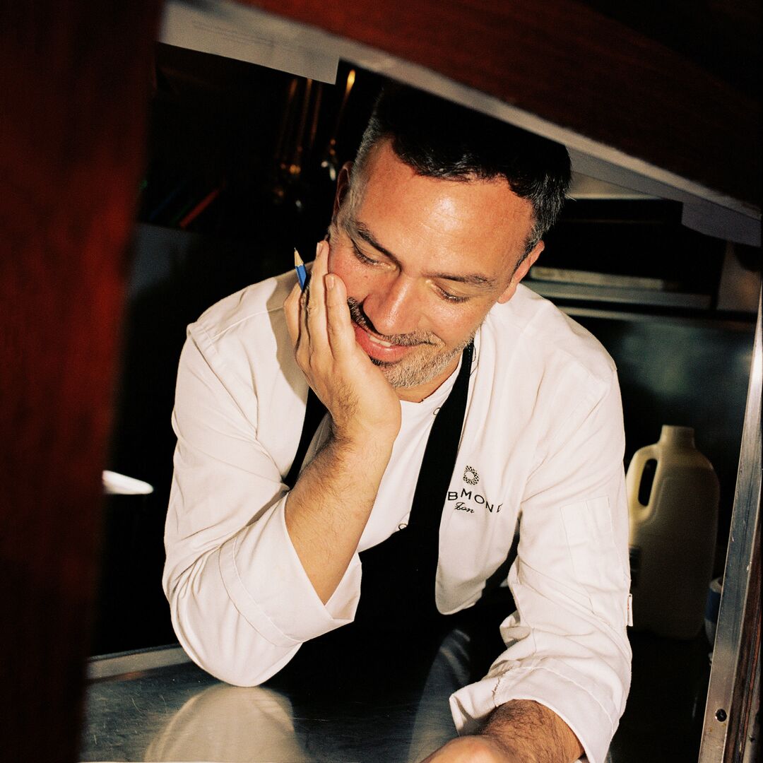 Chef holding pen in hand and looking at note