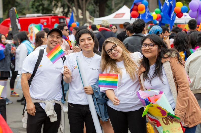Four employees celebrating Pride Parade