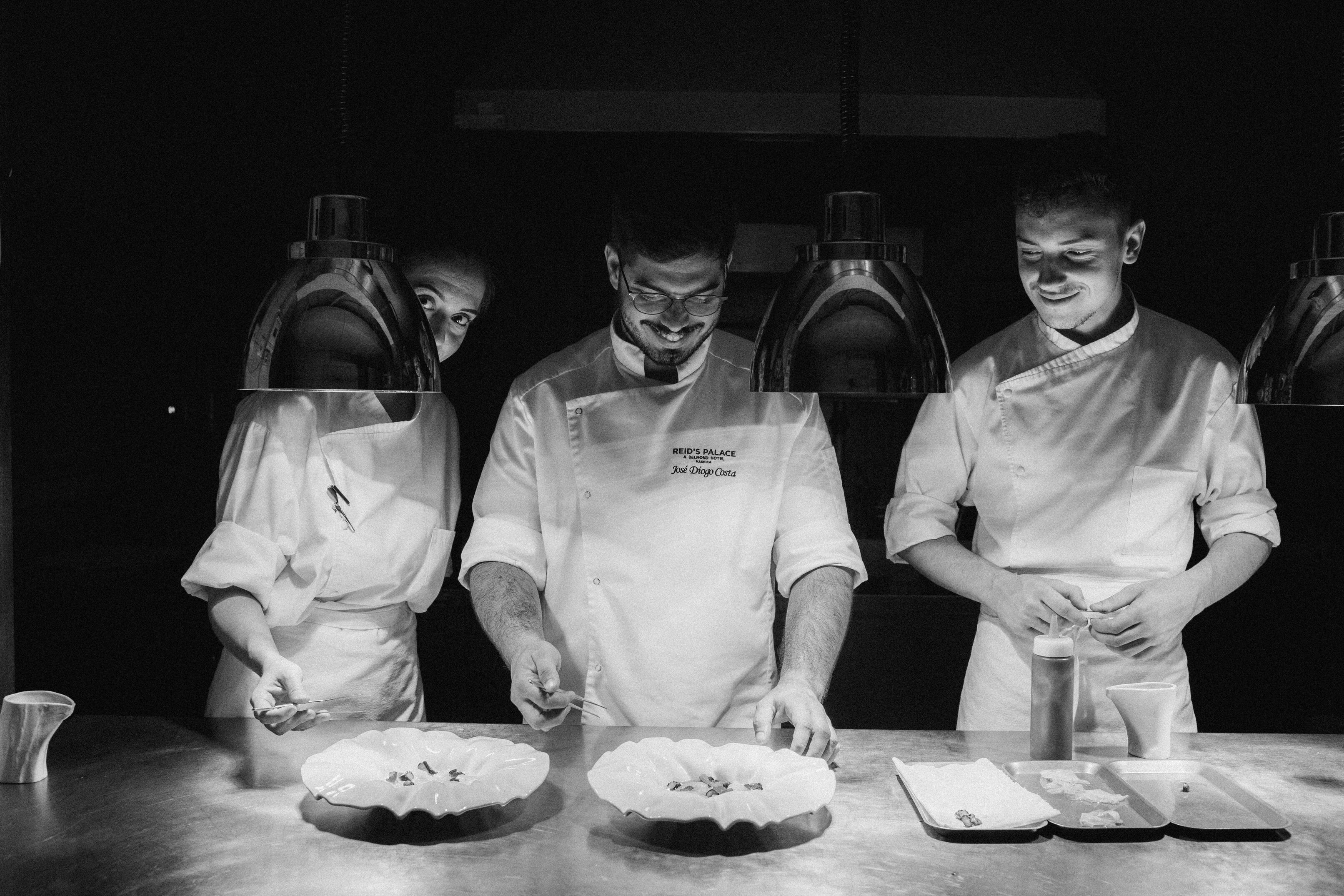 3 chefs  finalizing a dish