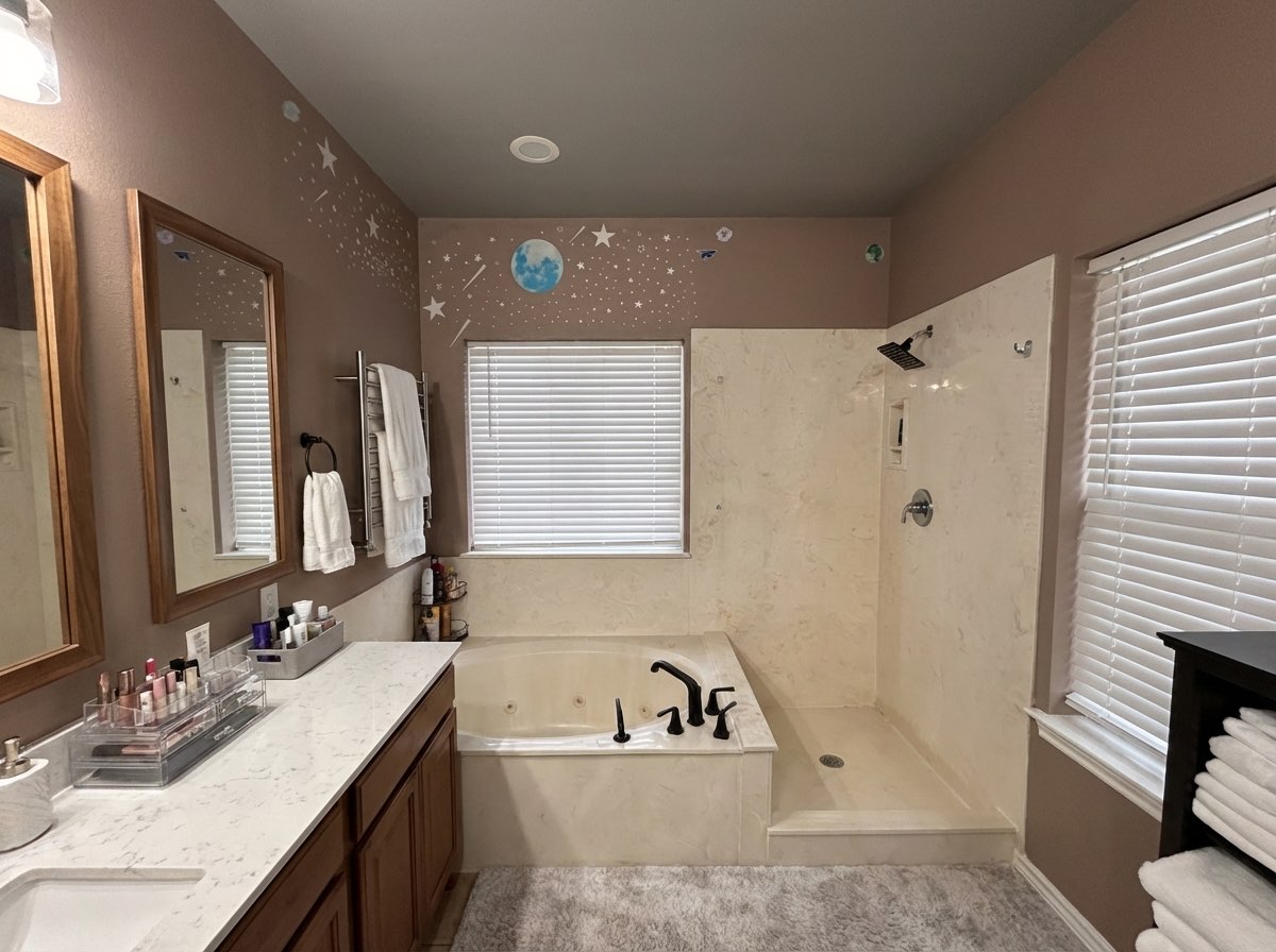 Bathroom transformation featuring modern lighting and clean lines