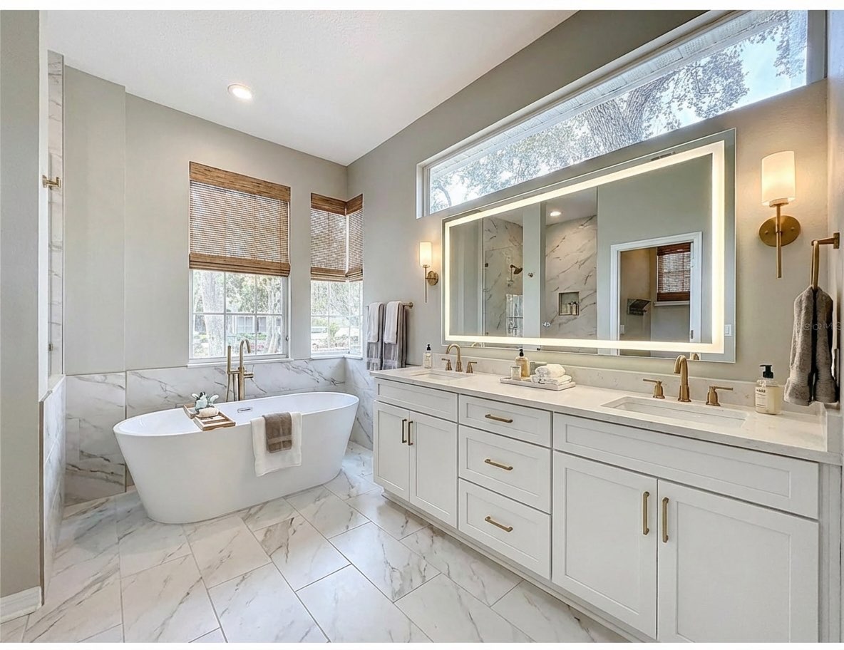 Bathroom transformation featuring modern lighting and clean lines