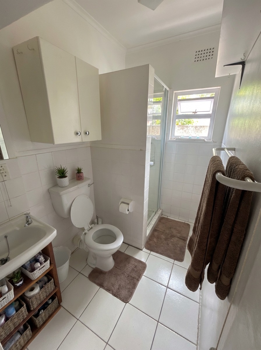 Transitional bathroom renovation with shaker cabinets and quartz counters