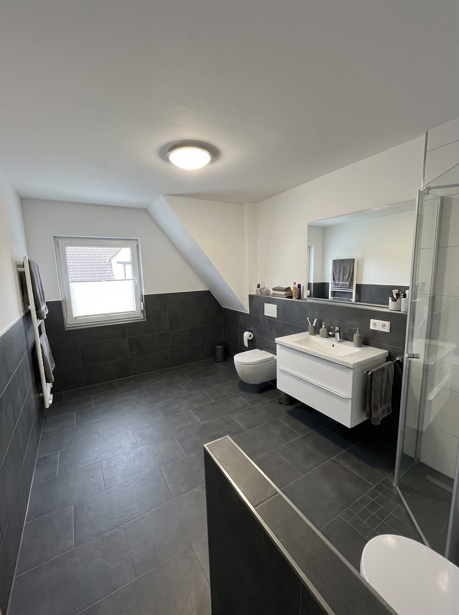 Transitional bathroom renovation with shaker cabinets and quartz counters
