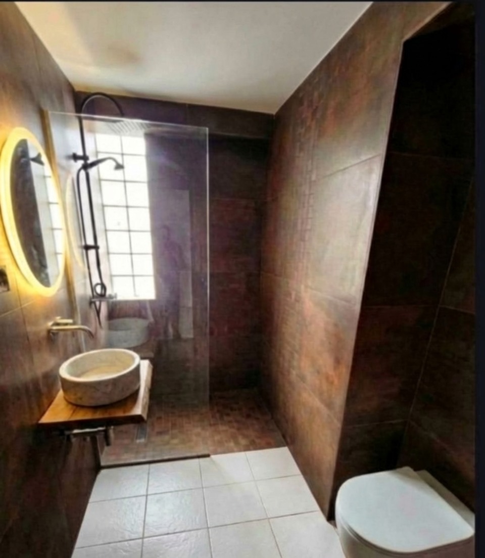 Terrazzo-style bathroom floor transformation with modern color palette