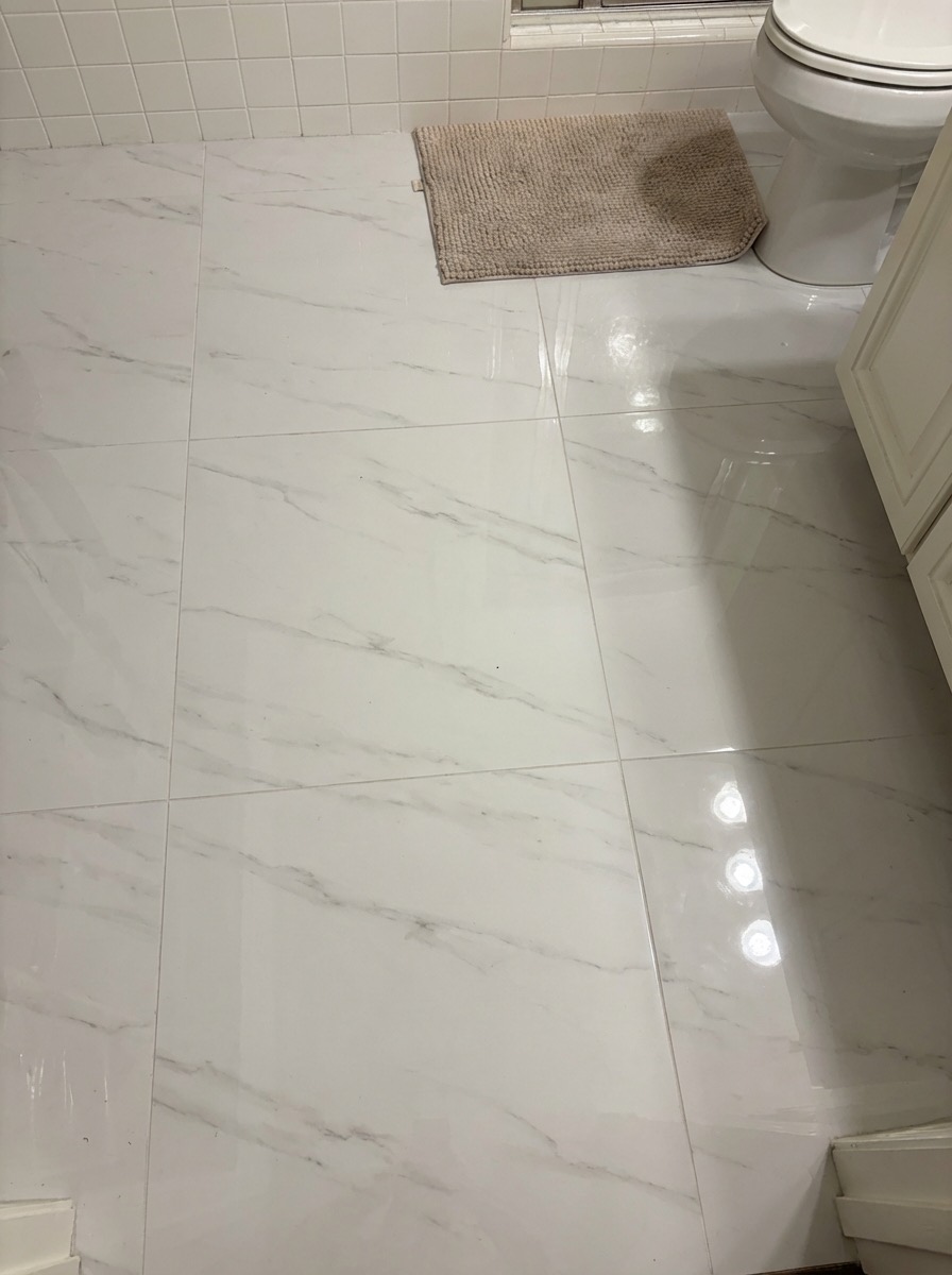 Terrazzo-style bathroom floor transformation with modern color palette