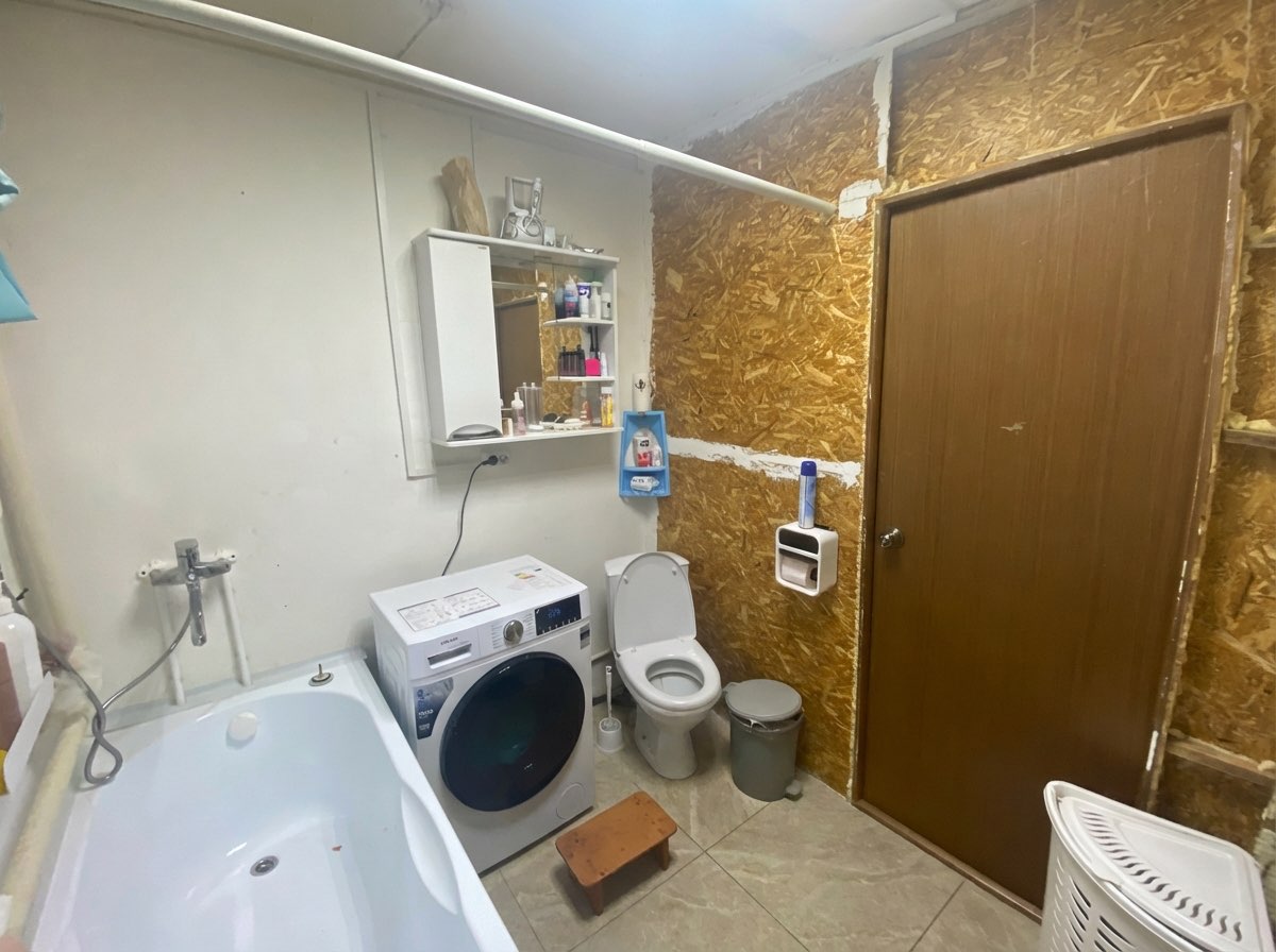 Bathroom floor renovation with herringbone tile pattern