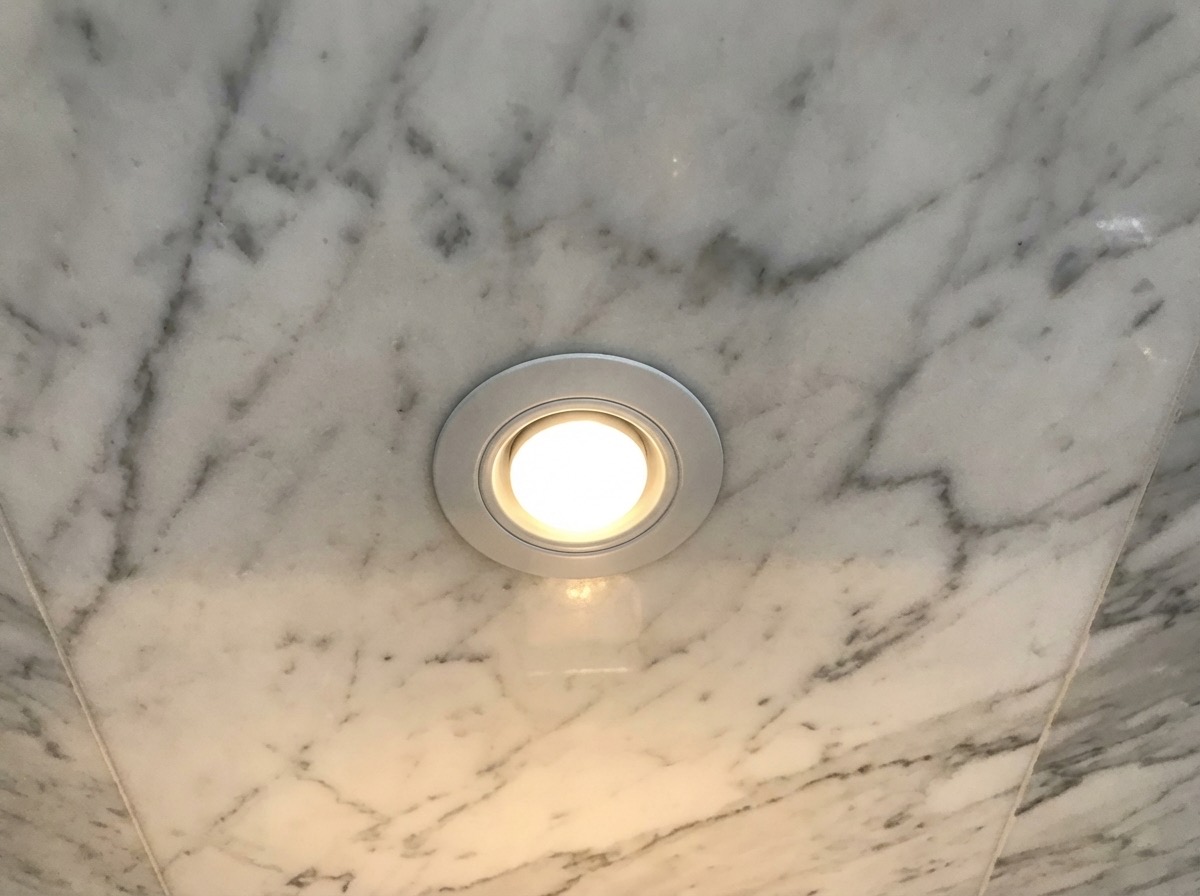 Bathroom wall makeover with penny tile accent strip and neutral base