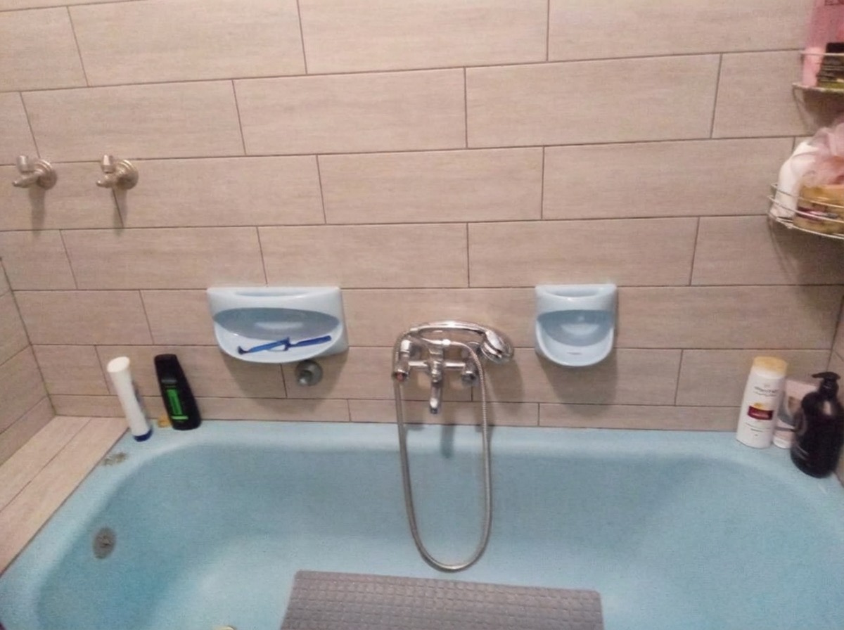 Wainscoting bathroom wall update with painted upper and tiled lower half