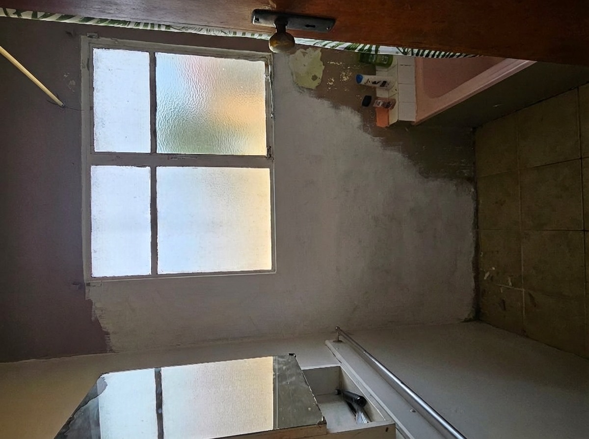 Bathroom soffit removed to reveal higher ceiling and more light