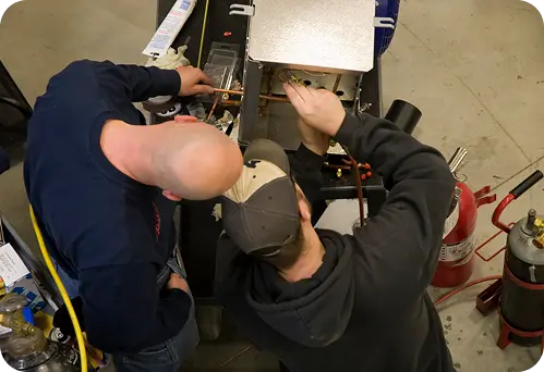 two male students working in skilled trades