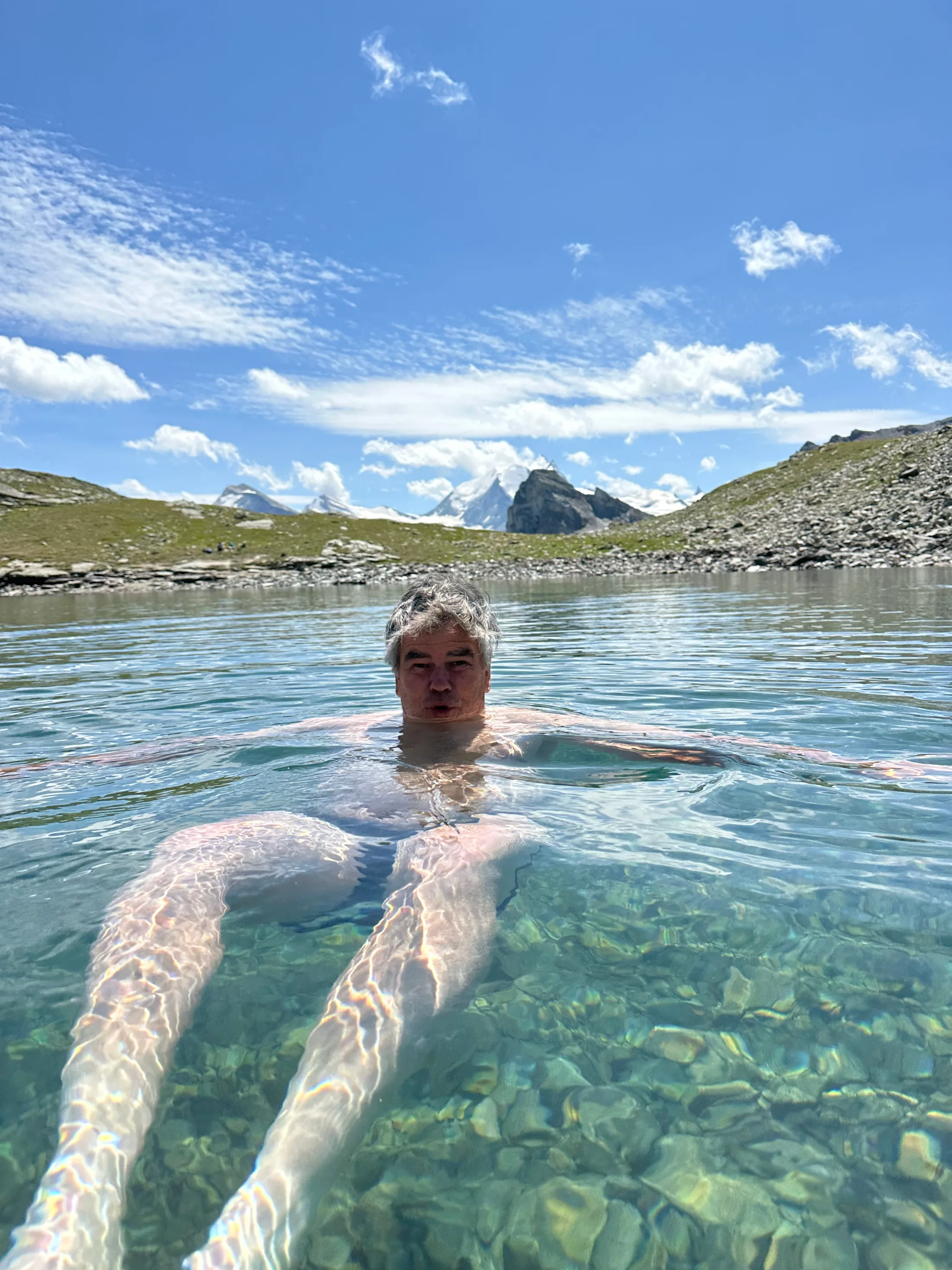 The best swim of the trip: a glacier-fed tarn below the pass, with the Matterhorn a tiny silhouette away to the south.