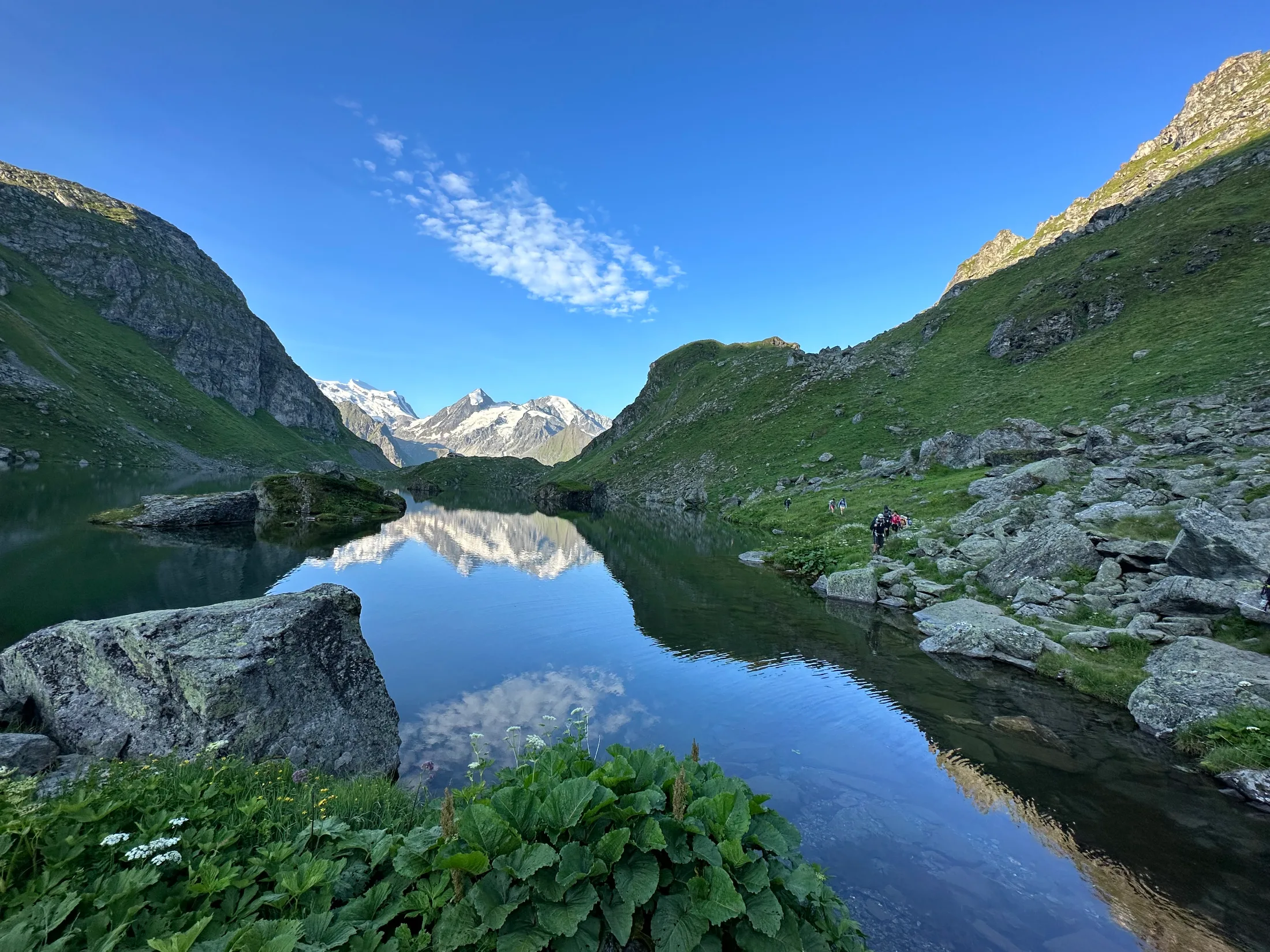 Snow peaks mirrored in Lac de Louvie, a few minutes' walk above the cabane.