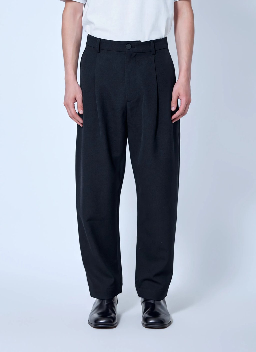 Studio Nicholson Tuck Cotton Tapered Leg Trousers in Black, Men's (Size 32)