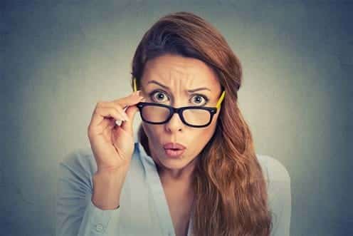 woman with glasses looking curious