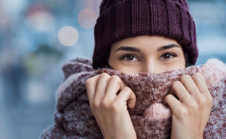 Mulher com gorro e manta no inverno