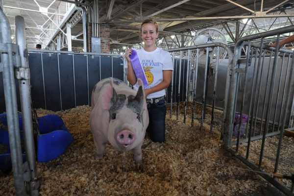 Erin Schmidt of Watkins and her FFA Purple award-winning hog.
