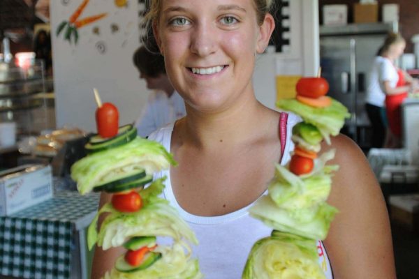 A Salad Bowl employee poses in the Agriculture Building with the popular Salad On-a-stick.