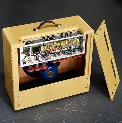 Milkman Sound amplifier with chassis open showing hand-wired internals