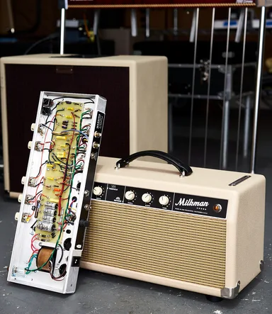 Milkman Sound HT15 amplifier alongside an open chassis in the shop
