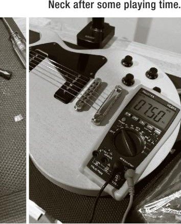 Bridge after some playing time — multimeter reading 7.50; Neck after some playing time