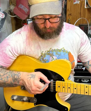Clancey Compton dialing in the intonation on a blonde Telecaster