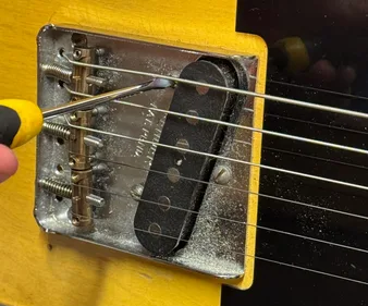 Close-up of Telecaster bridge with Groove Master saddles installed