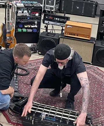Pedalboard Adventure — Justin and Bob Bradshaw working on the pedalboard
