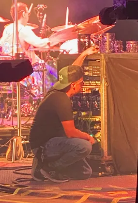 Justin working on the pedalboard during a show