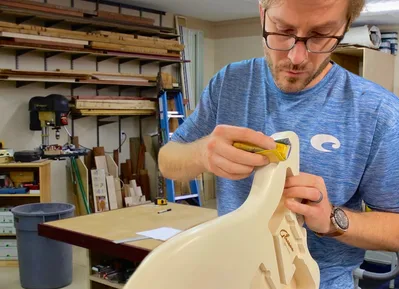 Cody Gleason working on a guitar body