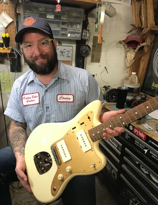 Clancey holding the Squier JM at his shop