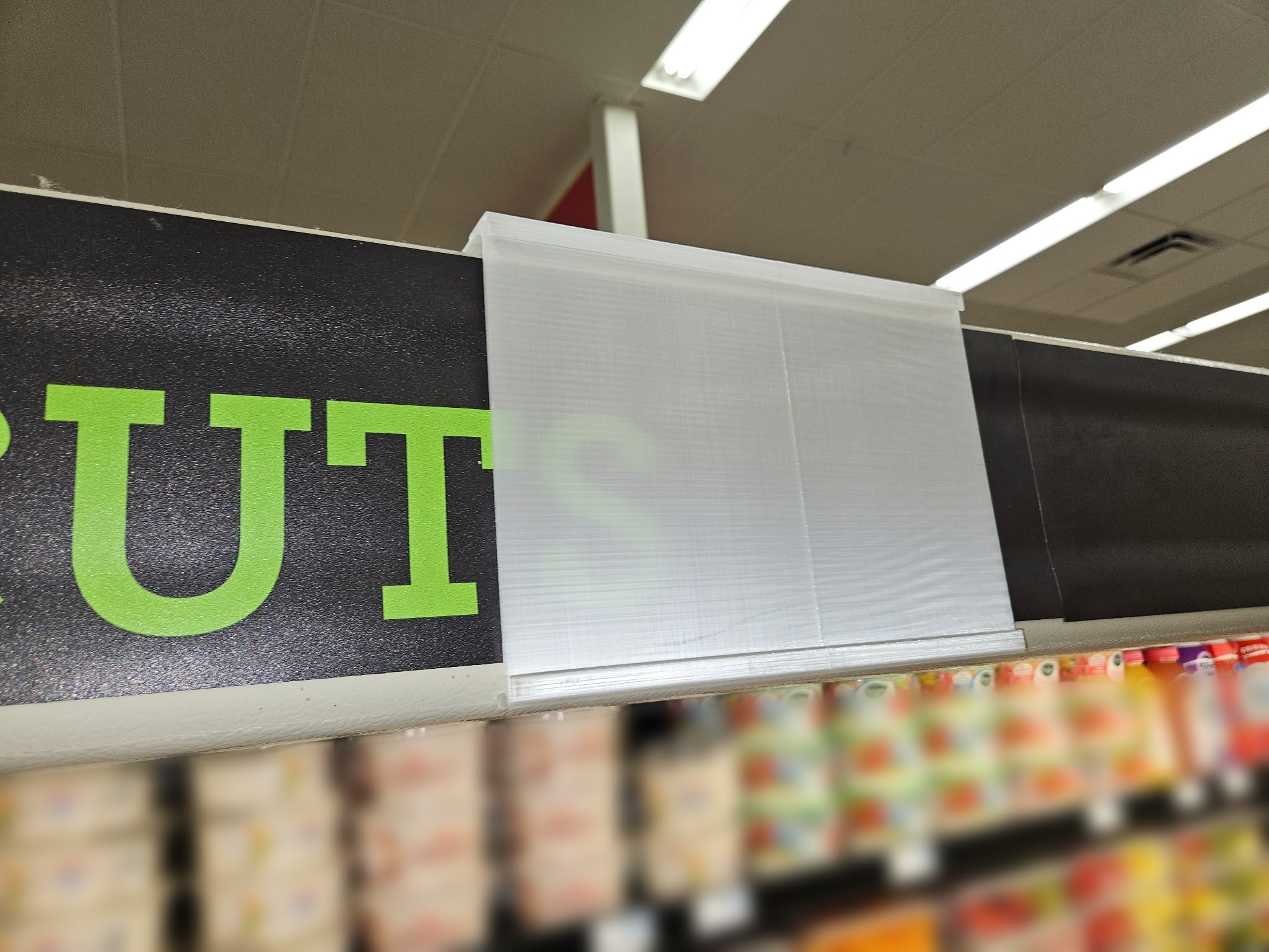 Single Label Canopy Bracket installed on a fresh-cut produce case