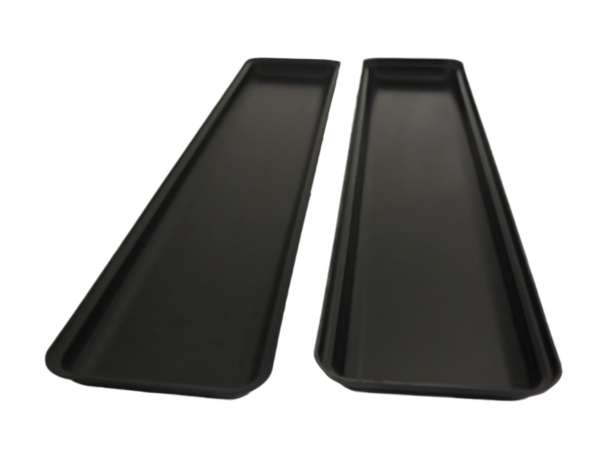 Two long black display trays for grocery store cases