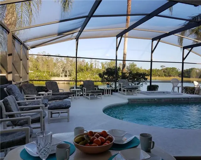Ellis Rentals: Pool deck and lounge seating overlooking the lake