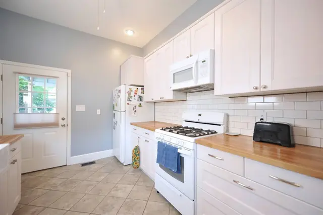 Garden Retreat: Kitchen with white cabinets and gas range