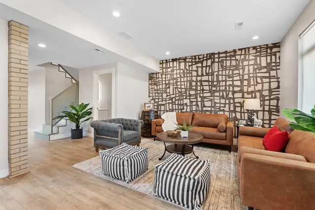 Prime NULU Escape: Sleek 4BR w/ Hot Tub & Style: Living room with leather sofas
