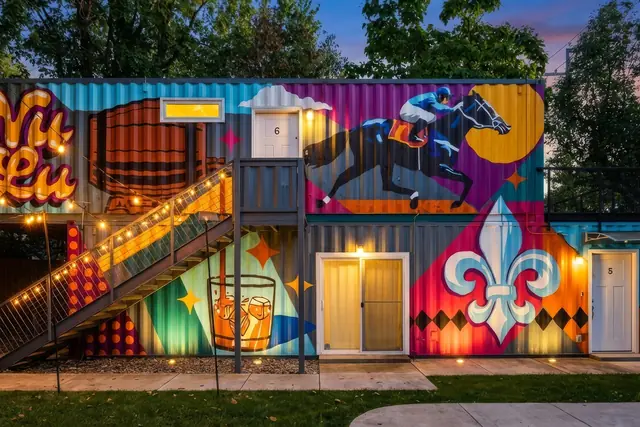 4-Unit Group Stay in NuLu | Shipping Containers 1-4: Mural-covered container exterior at dusk