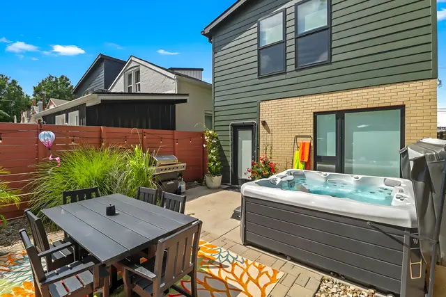 NuLu Oasis | 4 Bedroom Walkable Home with Hot Tub and Fire Pit: Backyard hot tub and dining table