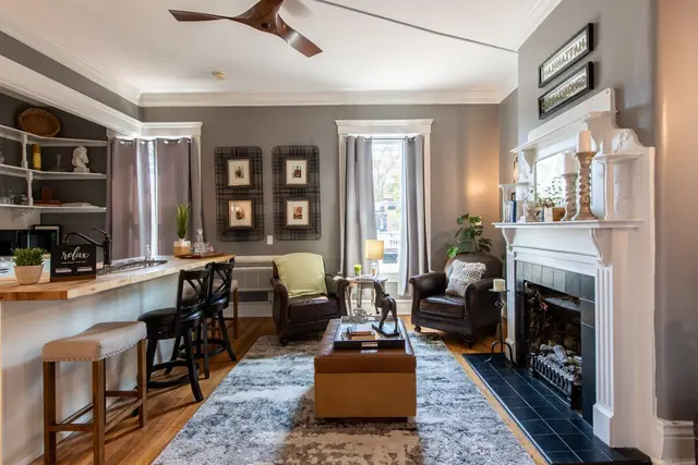 The Paddock Guesthouse | 9BR Highlands Home on Restaurant Row, Louisville: Living room with fireplace and breakfast bar