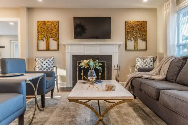 3BR Near EVERYTHING: Living room with fireplace and sofa